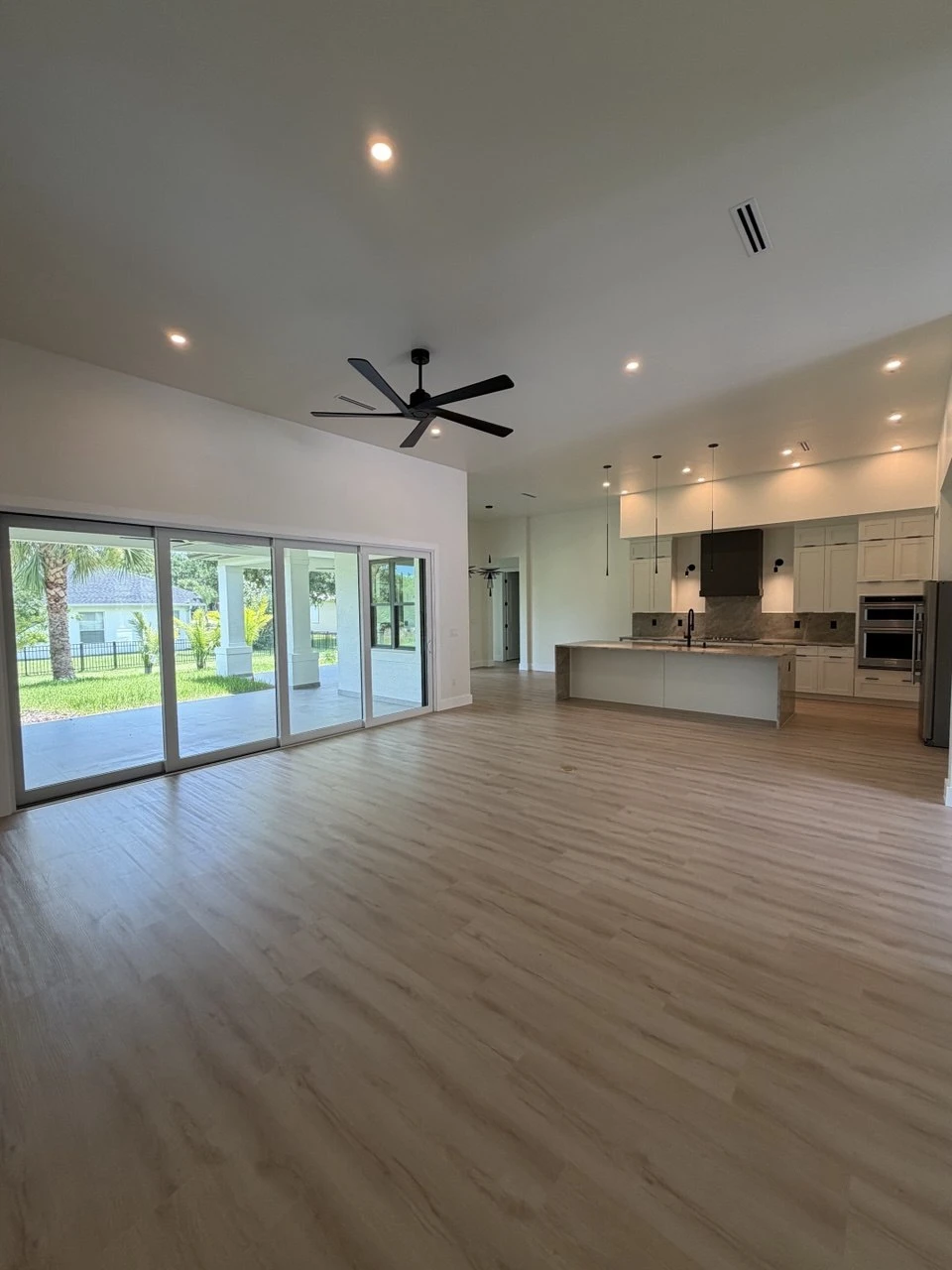 Open-concept living room and kitchen with waterfall island